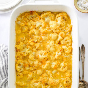 A serving dish containing baked cauliflower mac and cheese.