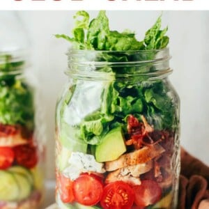 Mason jar filled with a chicken avocado club salad for meal prep.
