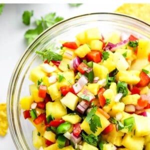 A closeup of pineapple salsa in a serving bowl.