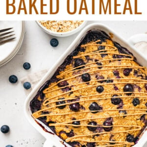 Protein baked oatmeal in a baking dish with bowls of blueberries and oats around it.