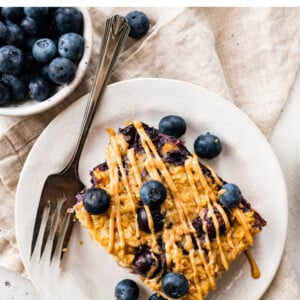A slice of protein baked oatmeal on a plate with a fork.