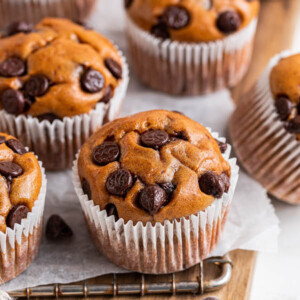 Protein muffins in paper wrappers on a wire rack.