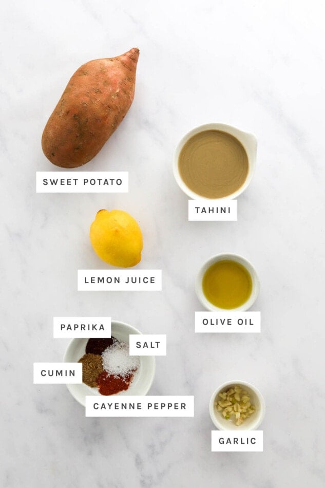 Ingredients measured out to make sweet potato hummus: sweet potato, tahini, lemon juice, olive oil, paprika, salt, cumin, cayenne pepper and garlic.