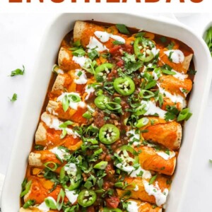 Baked vegan enchiladas topped with green onion and jalapeño slices.