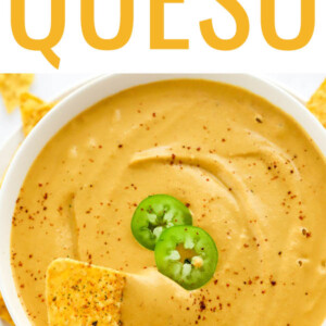 Scooping a chip in vegan queso.