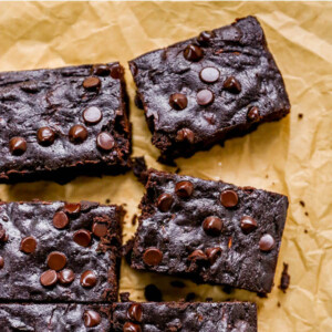 Zucchini brownies on a sheet of parchment paper.