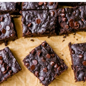Zucchini brownies on a sheet of parchment paper.