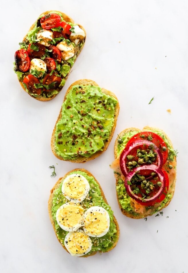Four variations of avocado toast.