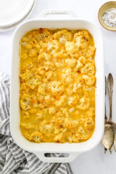 A serving dish containing baked cauliflower mac and cheese.
