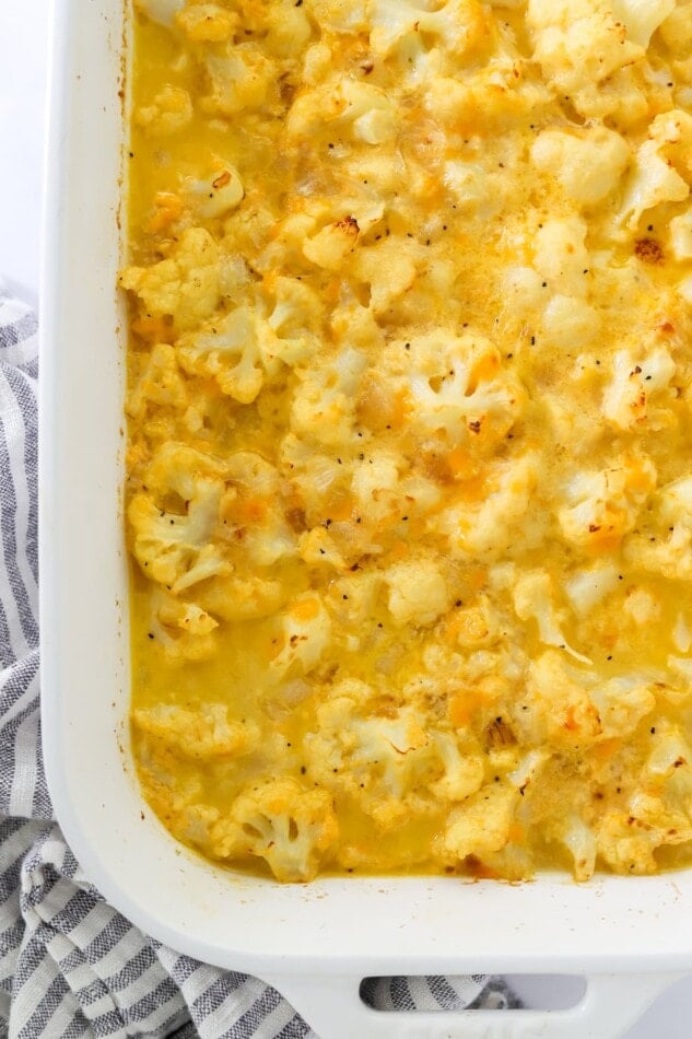 Close up of baked cauliflower mac and cheese in a baking dish.