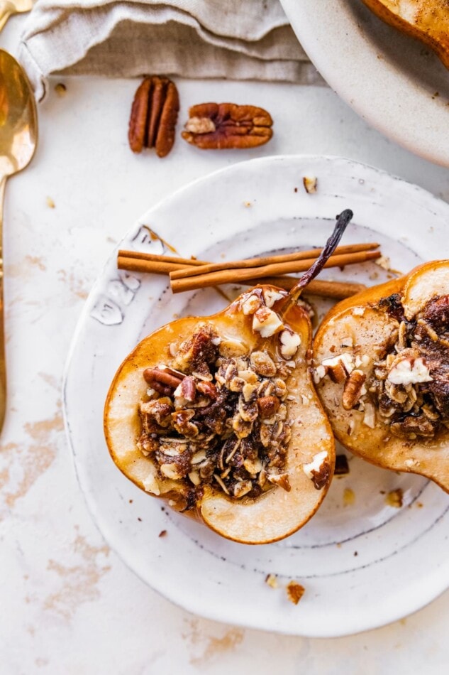 Two baked pear halves on a plate.