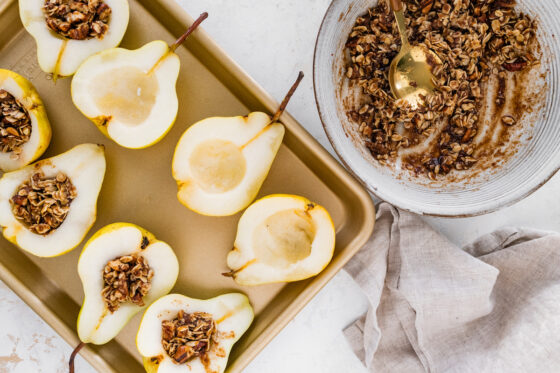 Adding mixture to the hollowed out pears.