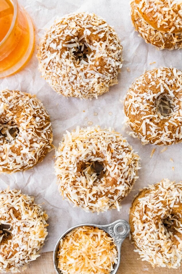 Overhead view of donuts on parchment paper.