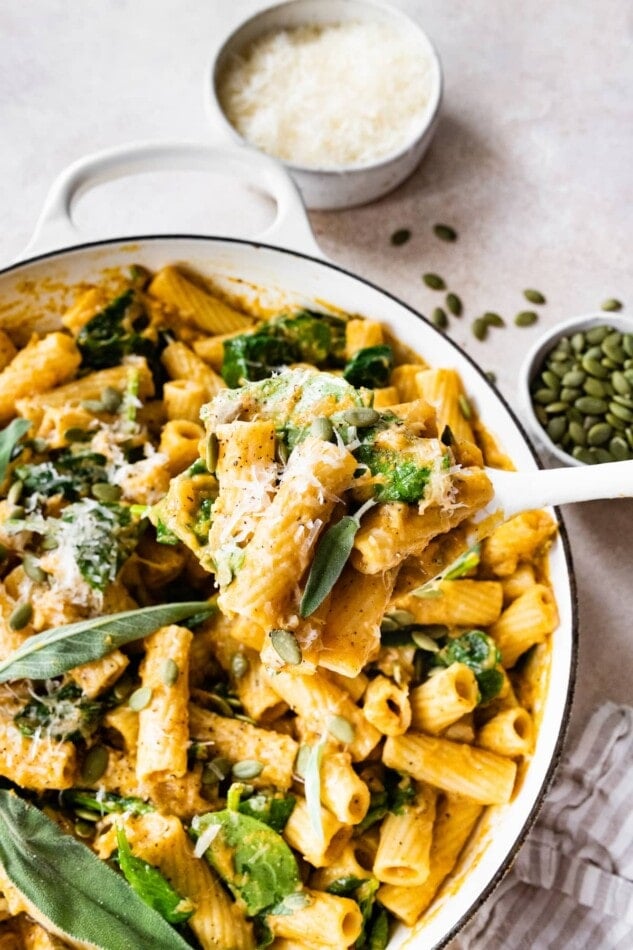 A pot with creamy pumpkin pasta.