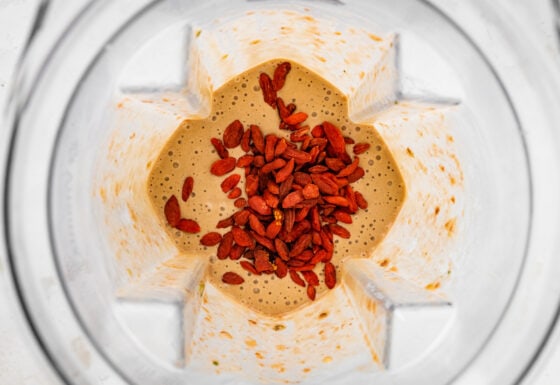 Goji berries added to smoothie mixture in a high powered blender.