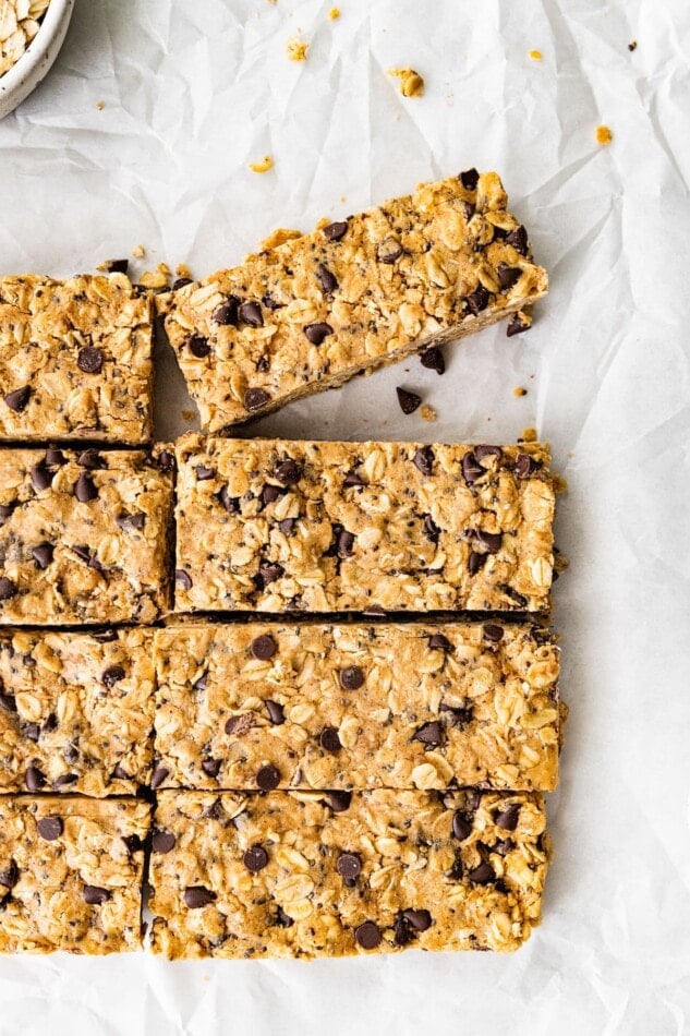 Peanut butter protein bars cut into rectangles on a sheet of parchment paper.