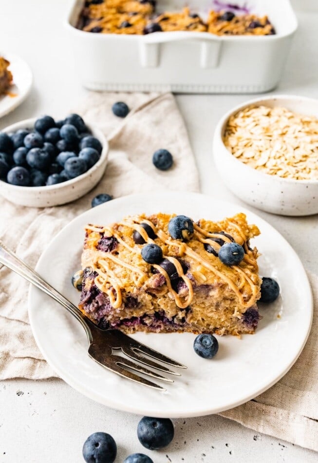 A slice of protein baked oatmeal on a plate with a fork.