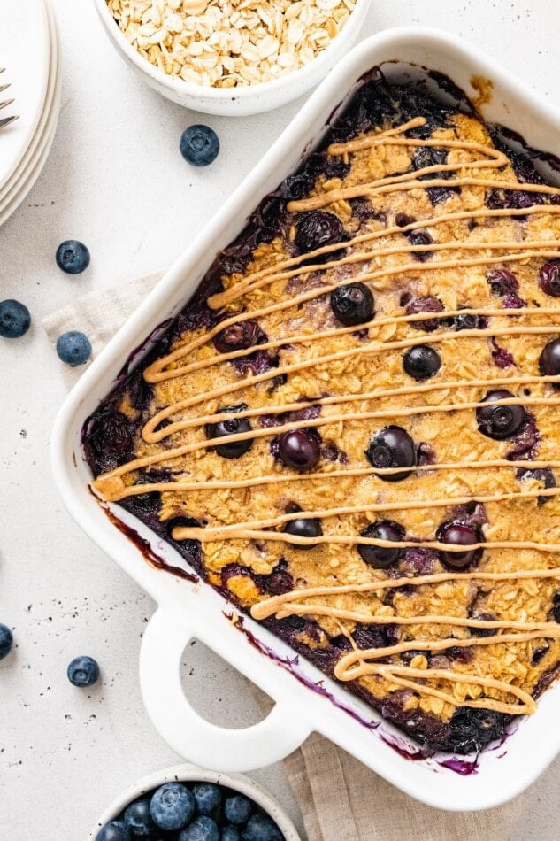 Overhead and closeup photo of protein baked oatmeal in a baking dish.