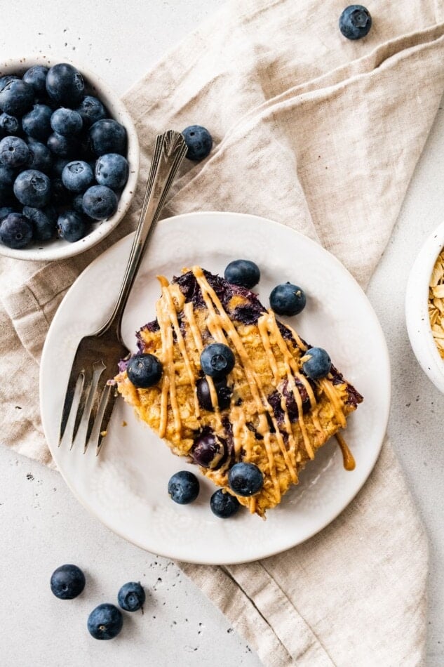 A slice of protein baked oatmeal on a plate with a fork.