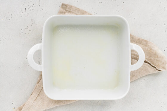 A square baking dish sprayed with non-stick spray.