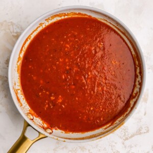 Chipotle peppers, adobo sauce, tomato sauce, oregano, chili powder, cumin, broth, salt and pepper in a sauce pan.