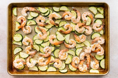 Zucchini, shrimp and spices after baking on a sheet pan.