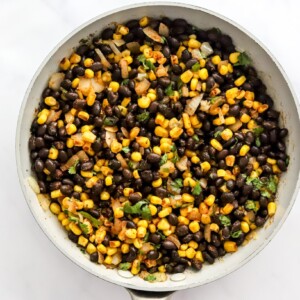 Cooking vegan enchilada filling in a sauté pan.