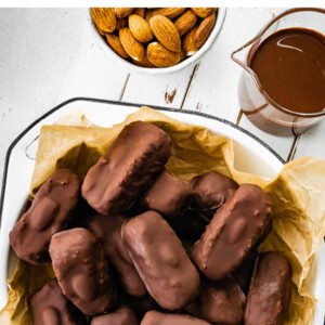 Homemade almond joy bars in a bowl lined with parchment paper.