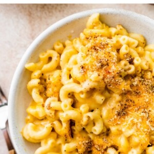 A bowl containing baked mac and cheese.