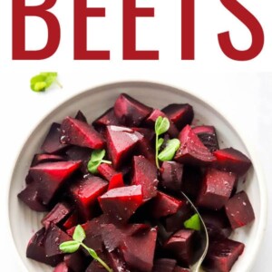 A bowl containing cooked, chopped beets with a serving spoon.