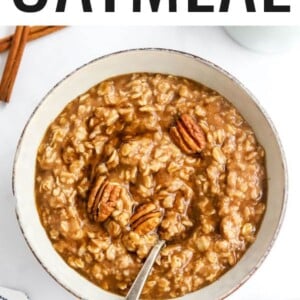 Bowl of maple brown sugar oatmeal topped with pecans. Spoon is in the bowl.