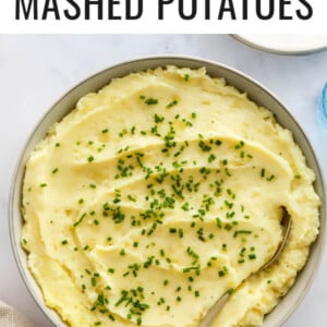 Healthy mashed potatoes in a bowl topped with chives.