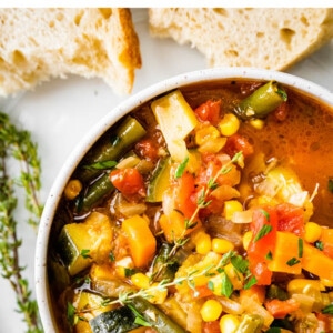 An overhead view of a bowl of vegetable soup.