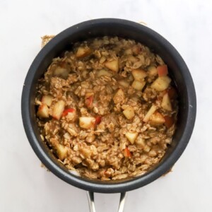 Apple cinnamon oatmeal cooked in a pot.