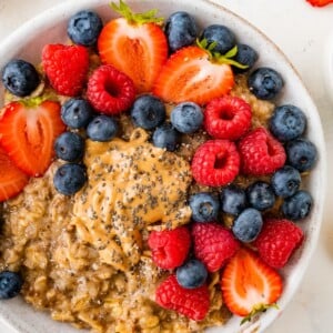 A bowl of cauliflower oatmeal topped with fresh mixed berries.