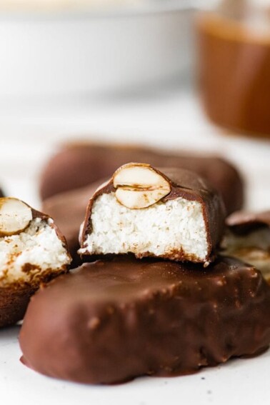 A halved almond joy bar stacked on top of a full bar.