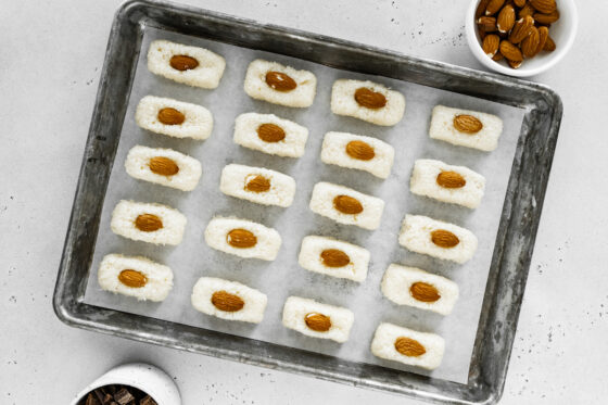 A single almond is placed upon the 20 coconut bars.