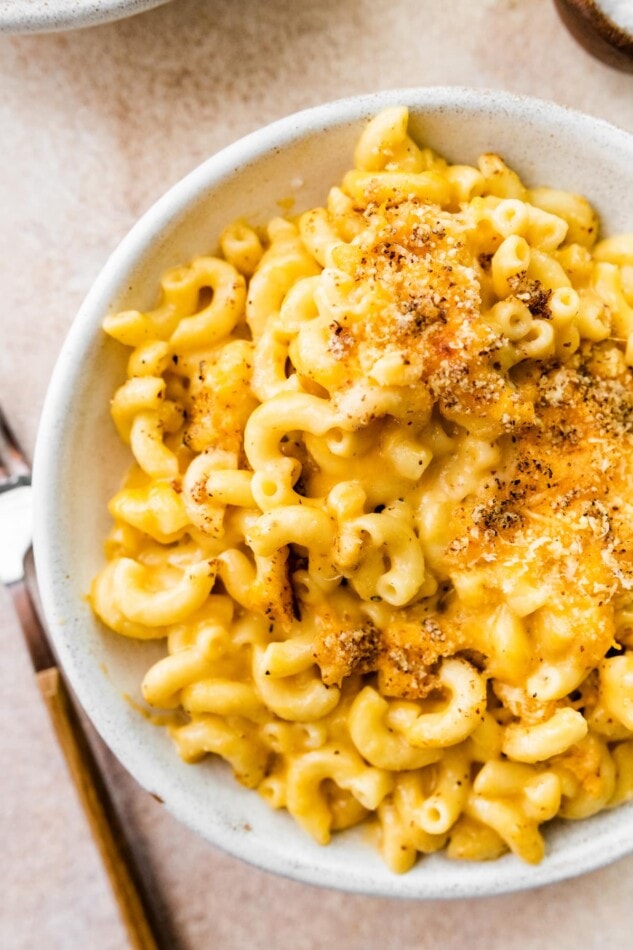 A bowl containing baked mac and cheese.
