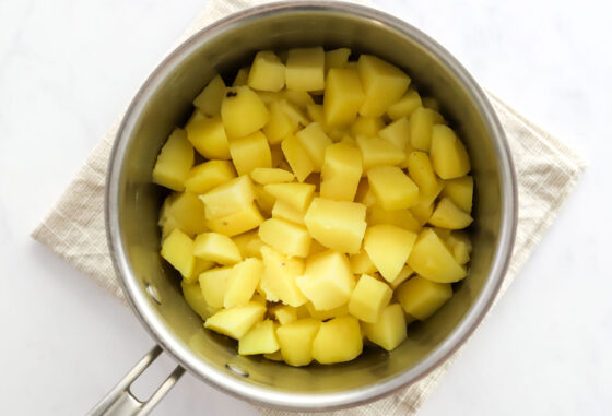 Boiled potato pieces in a pot.