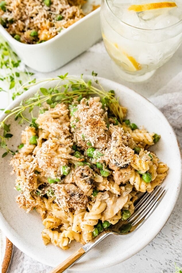 A serving of healthy tuna noodle casserole on a plate with a fork.