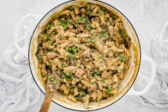 Tuna, peas and pasta noodles mixed in to the vegetables in the pot.