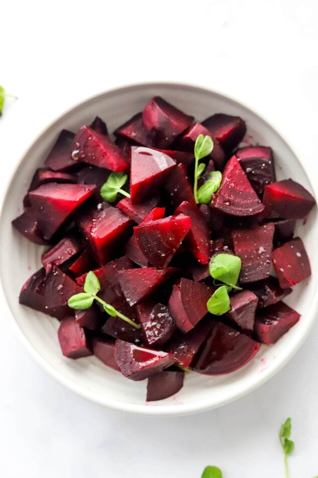 A bowl of chopped, cooked beets.