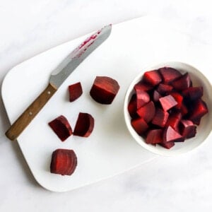 Chopping the cooked beets into bite size chunks.