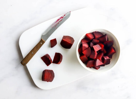 Chopping the cooked beets into bite size chunks.