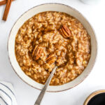 A bowl of maple brown sugar oatmeal with a spoon resting in the bowl.