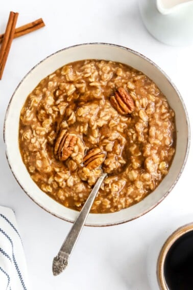 A bowl of maple brown sugar oatmeal with a spoon resting in the bowl.