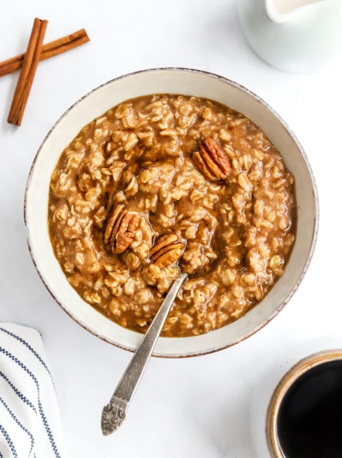 A bowl of maple brown sugar oatmeal with a spoon resting in the bowl.