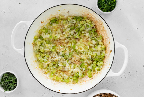 Onions, celery and garlic sautéing in a pot.