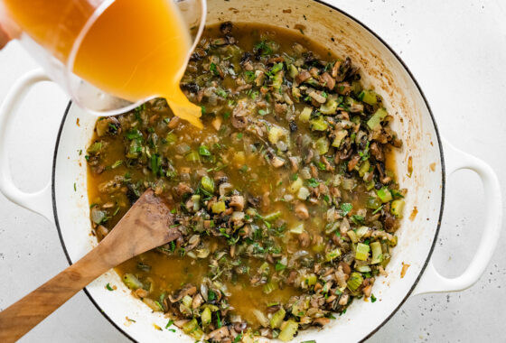 Pouring broth into pot.