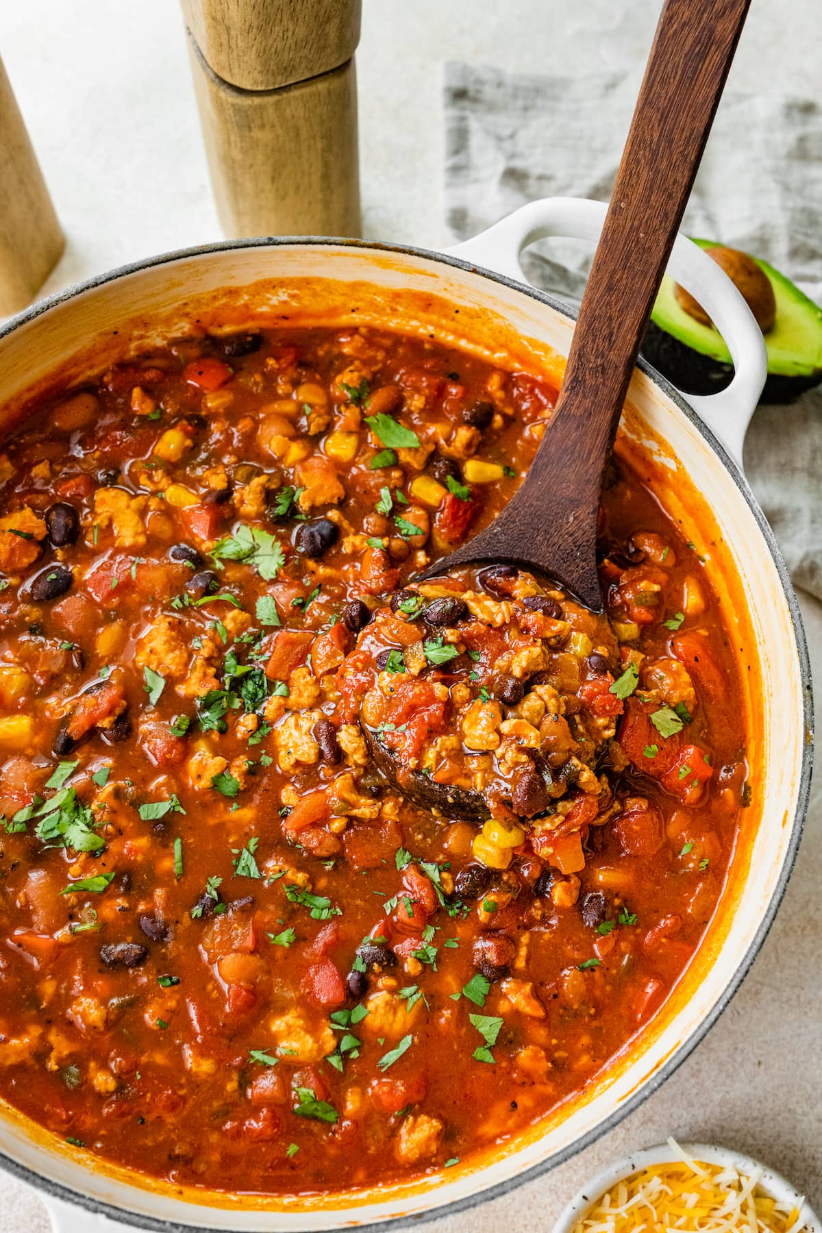 A pot of taco soup with a wooden spoon.